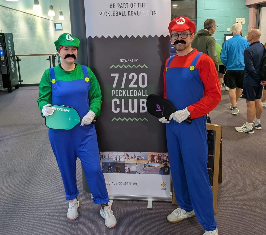 Black and white action shot of a player moving into position during a rally.